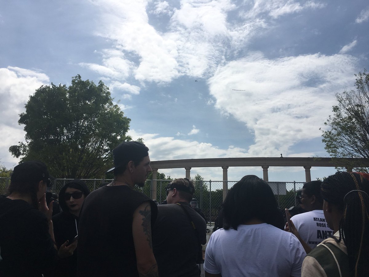 Air assault— Banner flying over site of neo-Nazi rally in downtown Newnan reads, Newnan believes in love for all. Counter demonstrators are cheering, chanting, waiting to see if the neo-Nazis show up. The group's permit for the rally was for 3:00-5:00 ET - 11Alive   