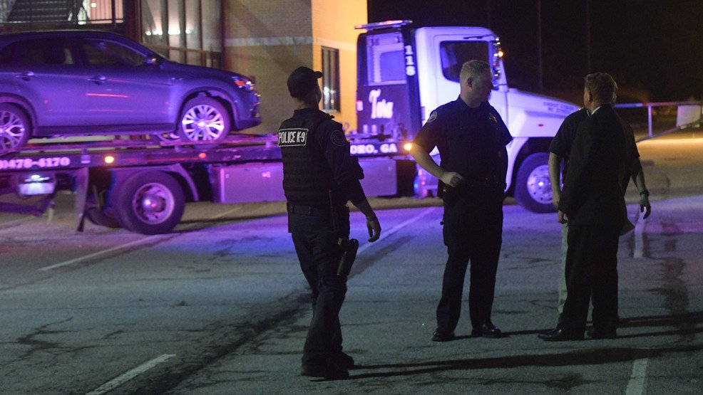Police announced the arrests of two people Saturday in a fatal shooting outside a high school graduation ceremony in Georgia.