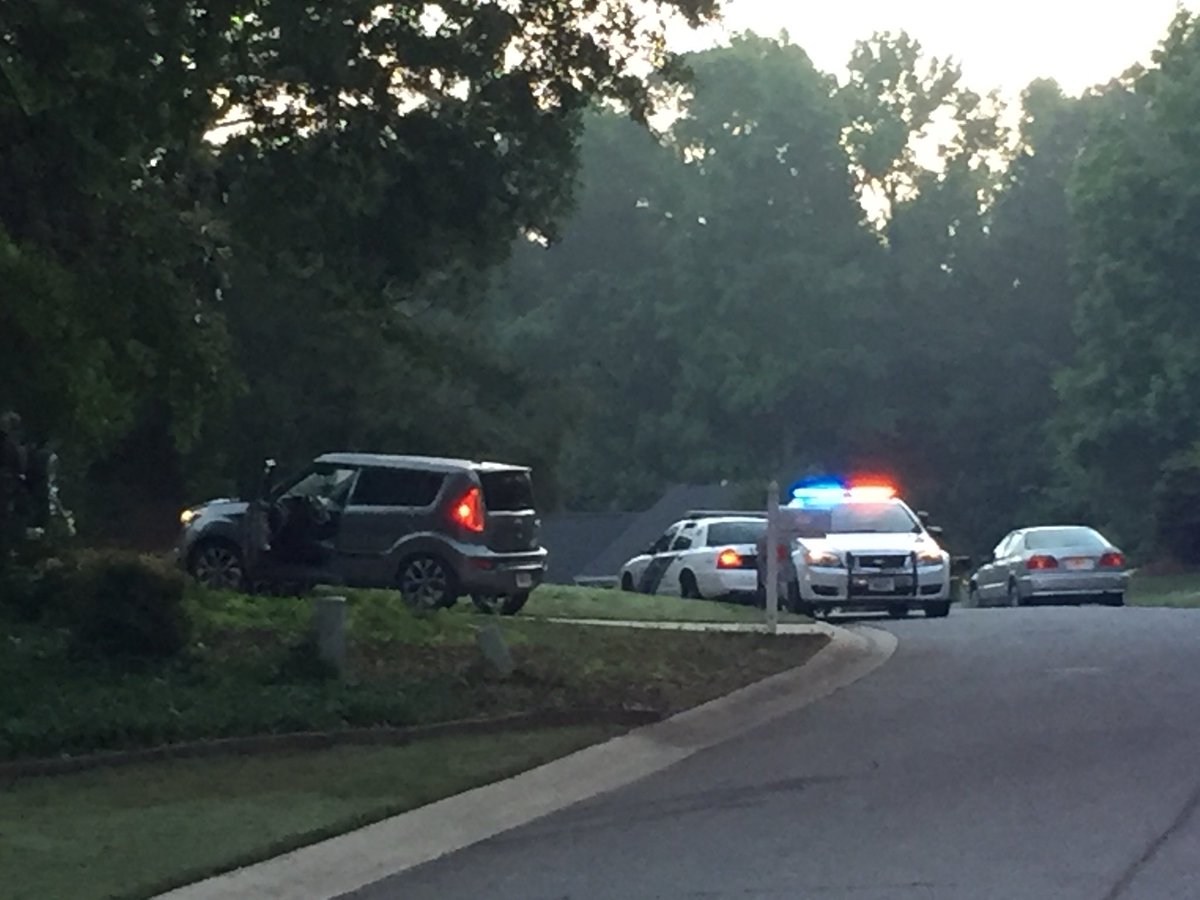 An investigator took photos of this grey car in the driveway of the home where Peachtree City Police say someone assaulted one of their officers and someone fired a gun.   