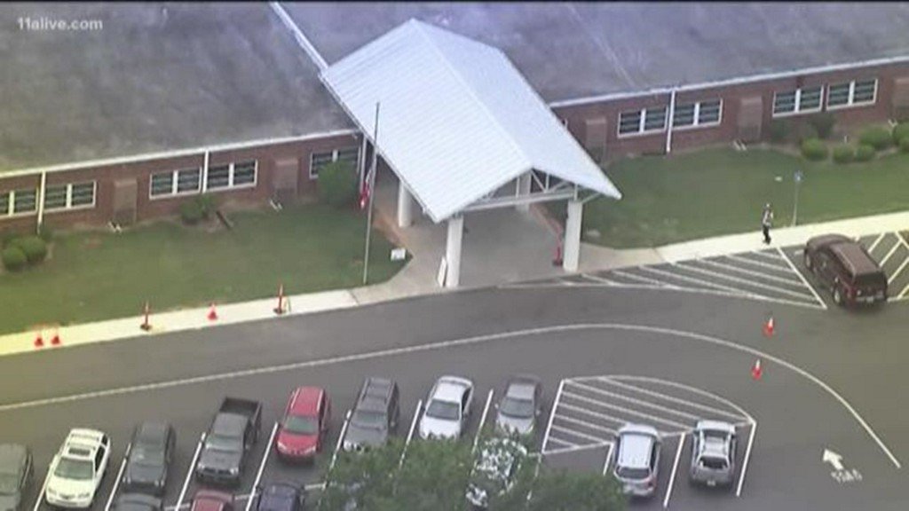 Investigators are processing a crime scene in front of an elementary school after a shooting in Spalding County. The shooting apparently happened in the parking lot of Beaverbrook Elementary School Monday afternoon according to a statement from the Spalding County Sheriff's Office.
