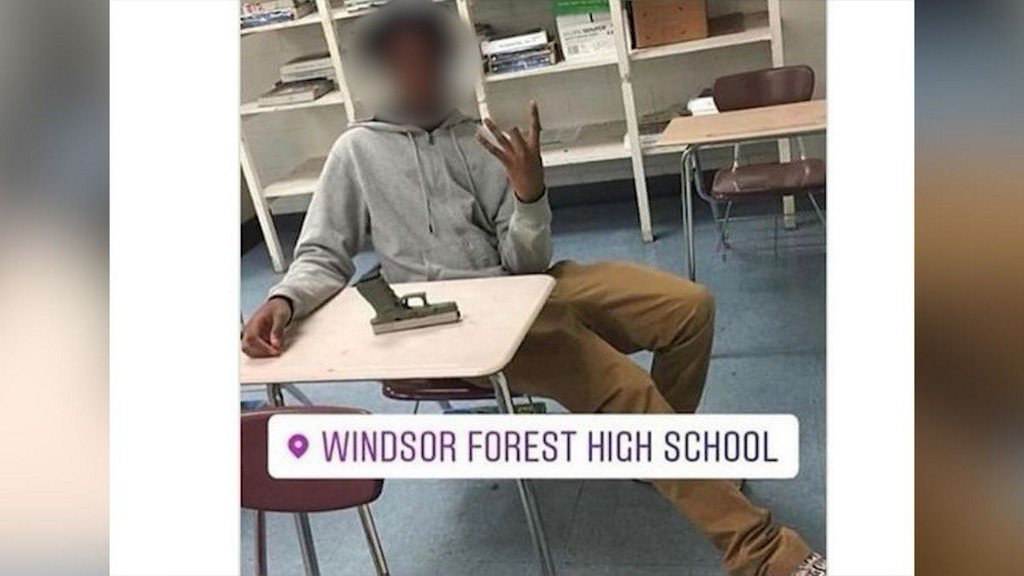 A gun in the classroom Campus police are investigating a photo of a Windsor Forest student with gun on a desk    