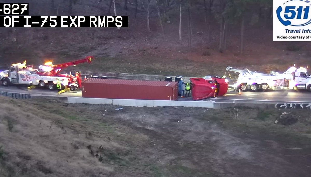Two heavy duty wreckers to upright this big rig on its side I-285/eb ramp to I-75/nb (exit 20) shut down in the Cobb Cloverleaf.
