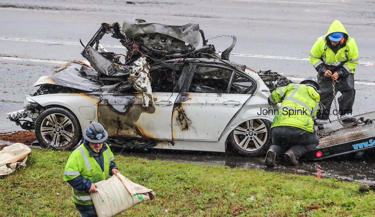 Vehicles are   moved off to the side by wreckers on I-285 west at Riverdale Road as only 2-lanes are open, backing traffic to I-675 