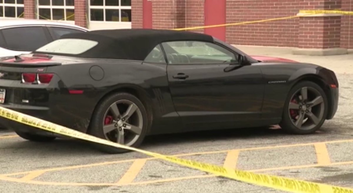 Bullet holes in the front windshield of car parked in S