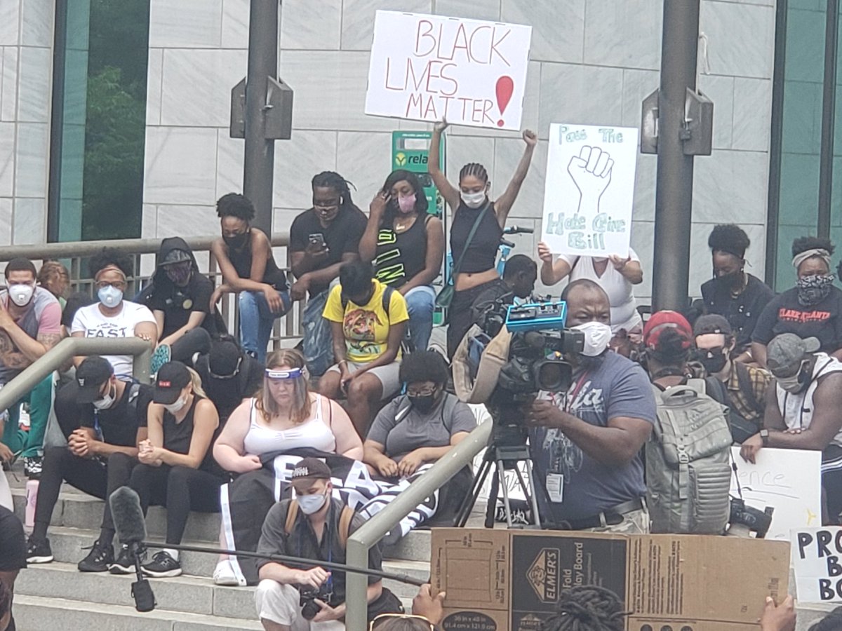 Protestors kneel for a moment of silence for all those who have died at the hands of police officers at Atlanta City Hall.