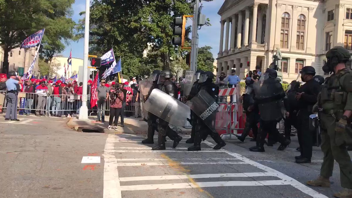 Police in riot gear have   come in to block the two opposing groups
