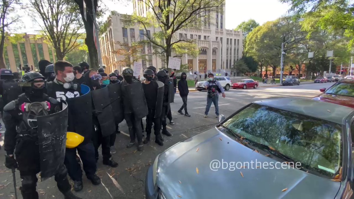 Antifa  over one of the Trump supporters as she moves her car off the street Atlanta Georgia 