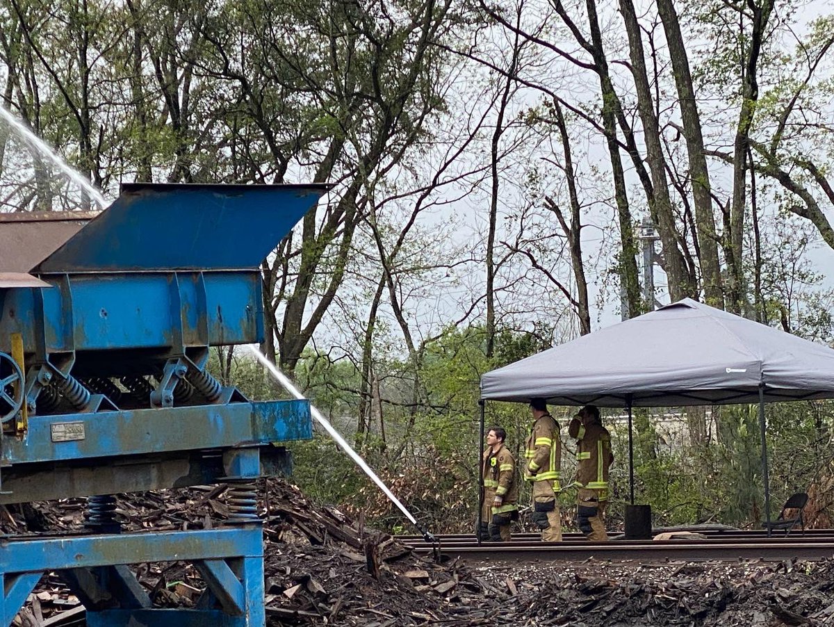 Savannah Firefighters continue to pump water onto the smoldering wood chip pile at a Louisville Road recycling center