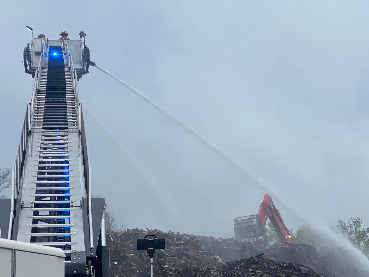 Savannah Firefighters continue to pump water onto the smoldering wood chip pile at a Louisville Road recycling center