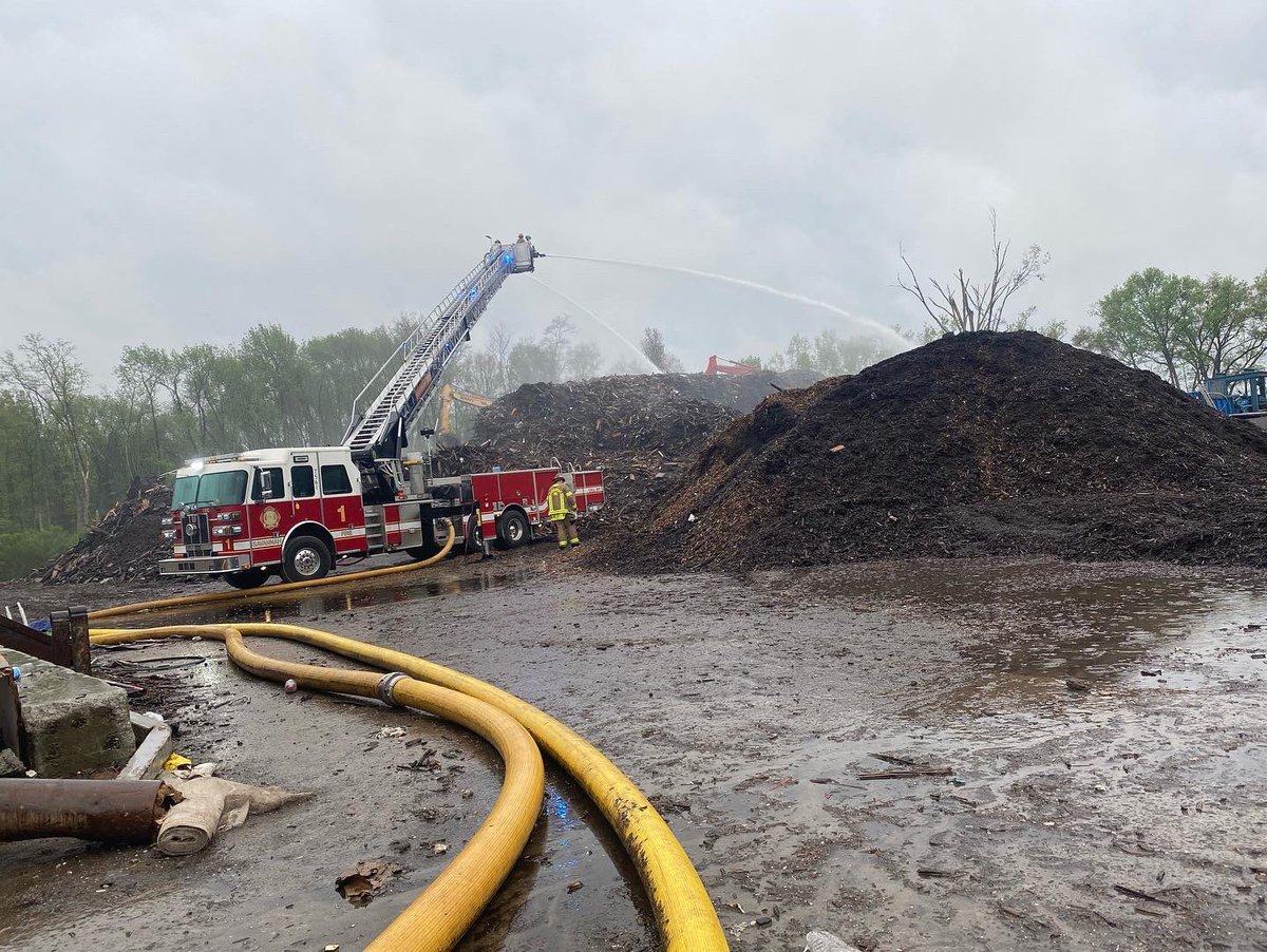 Savannah Firefighters continue to pump water onto the smoldering wood chip pile at a Louisville Road recycling center