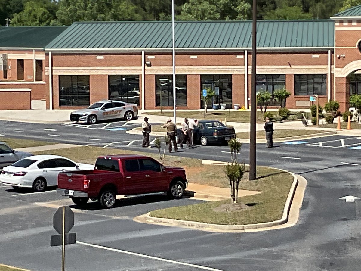 South Hart Elementary School where double homicide vehicle/suspect was found. Sheriff on scene looking inside the vehicle. GSP troopers and Hart County deputies on scene