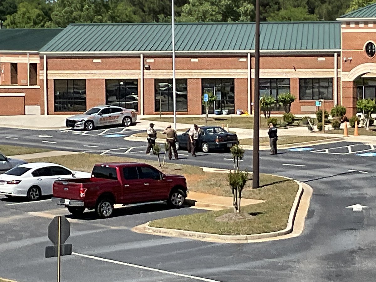 South Hart Elementary School where double homicide vehicle/suspect was found. Sheriff on scene looking inside the vehicle. GSP troopers and Hart County deputies on scene