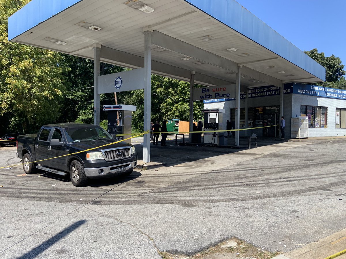 Atlanta Police investigating fatal shooting near Jonesboro Rd SE and School Dr SE. 20+ evidence markers on the ground outside of a gas station. K-9 unit searching area. Police are also at a second scene nearby on Jonesboro Rd outside several townhomes