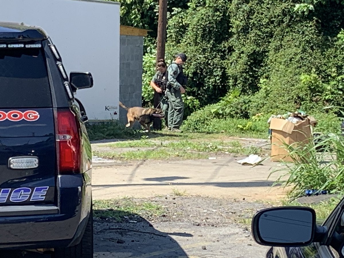 Atlanta Police investigating fatal shooting near Jonesboro Rd SE and School Dr SE. 20+ evidence markers on the ground outside of a gas station. K-9 unit searching area. Police are also at a second scene nearby on Jonesboro Rd outside several townhomes