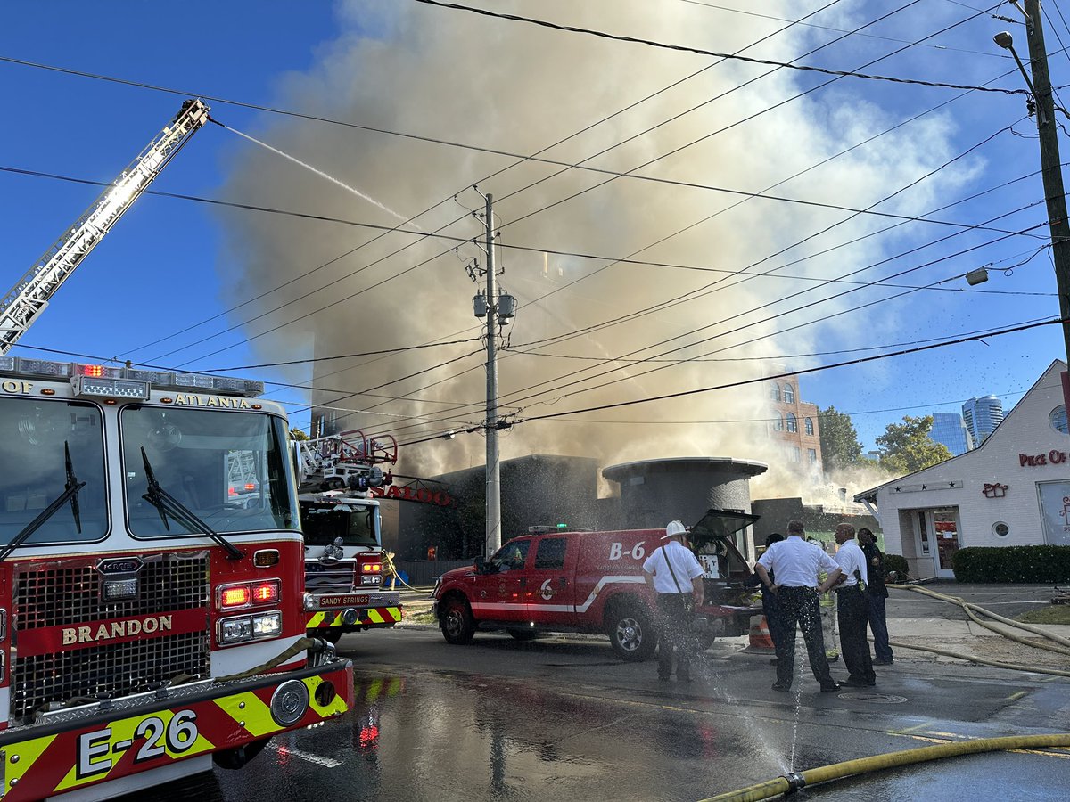 Still see flames coming from Buckhead Saloon. Witness said started small in back/kitchen area after 8:15 and grew quickly. Firefighters were here within seconds as station only two doors down on Roswell Rd