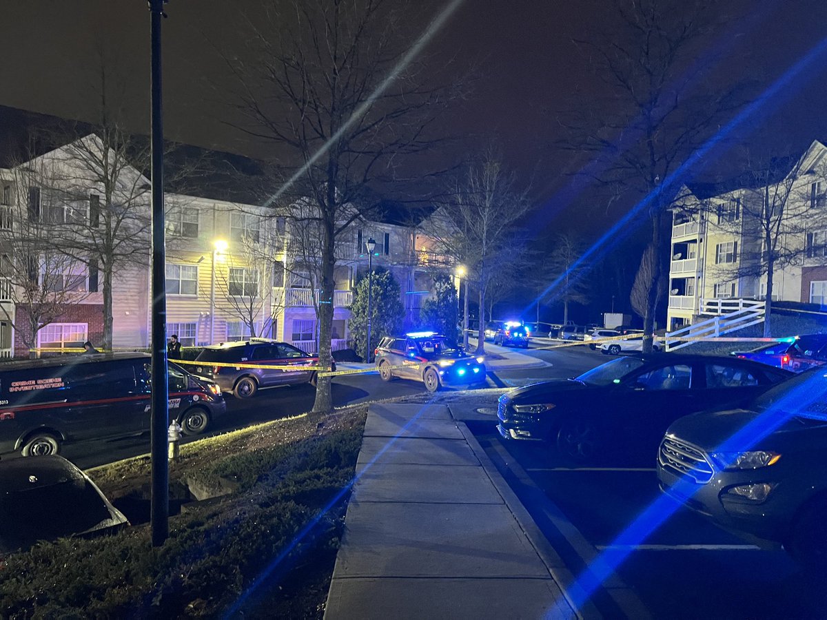 Homicide scene of a deadly shooting at The Peaks at MLK on M.L.K Jr SW in Atlanta. Atlanta Police officers have a large section of the parking lot roped off. Witnesses heard multiple shots fired. Victim appears to be slumped over SUV at end of one of the buildings